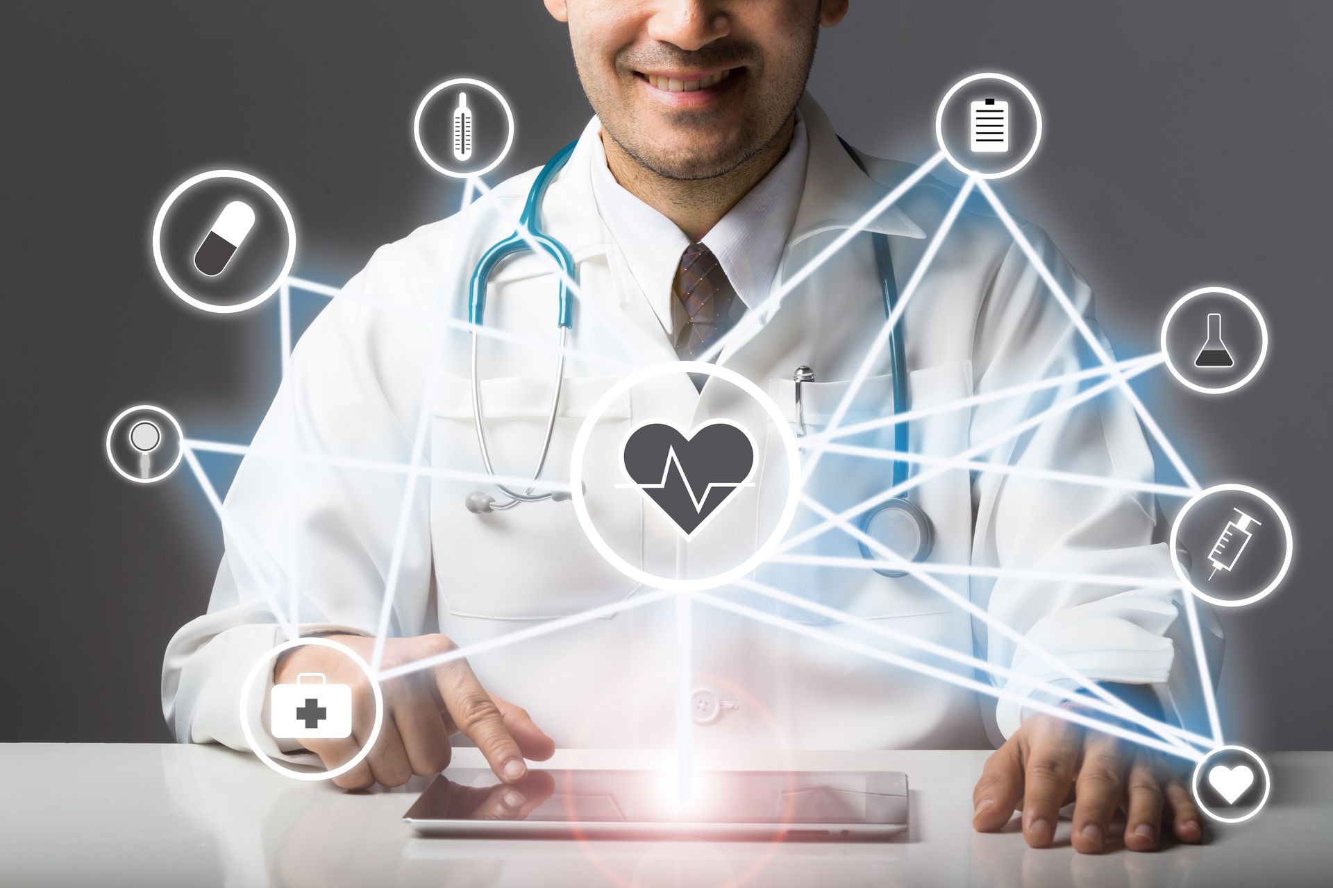 Doctor with stethoscope using computer tablet to connect Medical Healthcare Network for diagnosis and use Medical Services with white icon medical on screen,Medical technology network and IOT concept